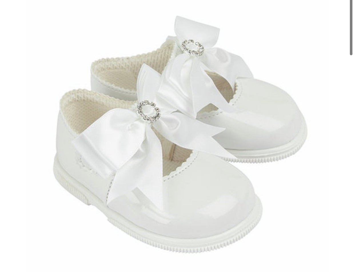 Hard soled white bow shoes