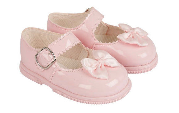 Pink hard soled bow shoes